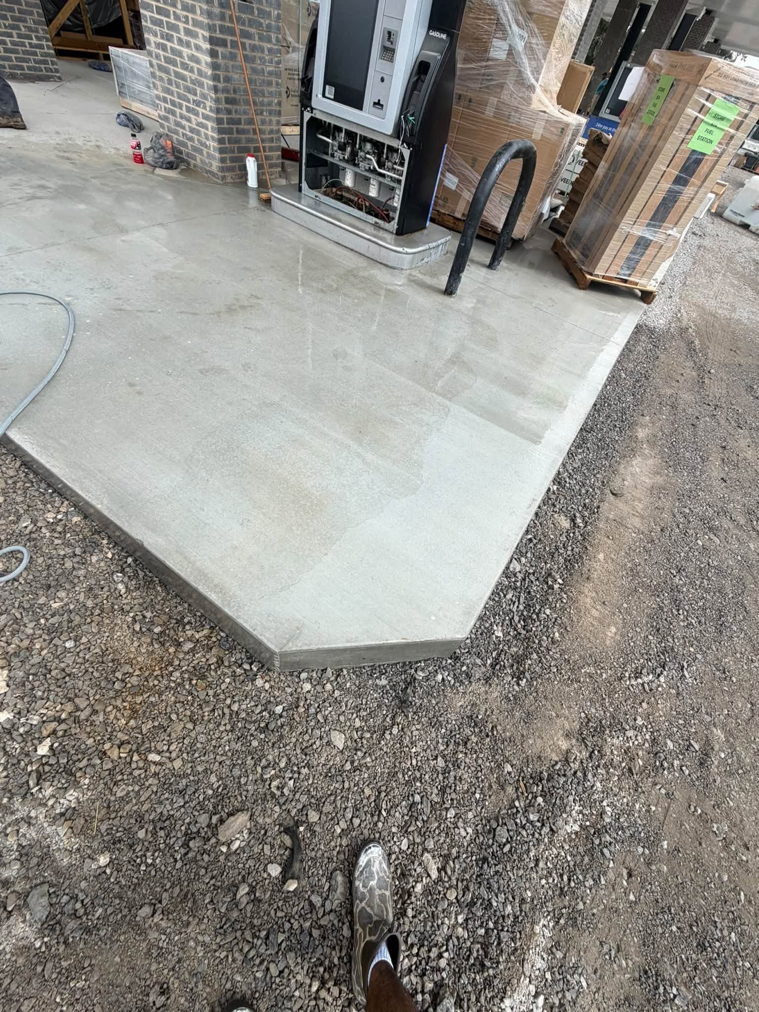 The same fuel-island pad after commercial pressure washing, rust stain gone