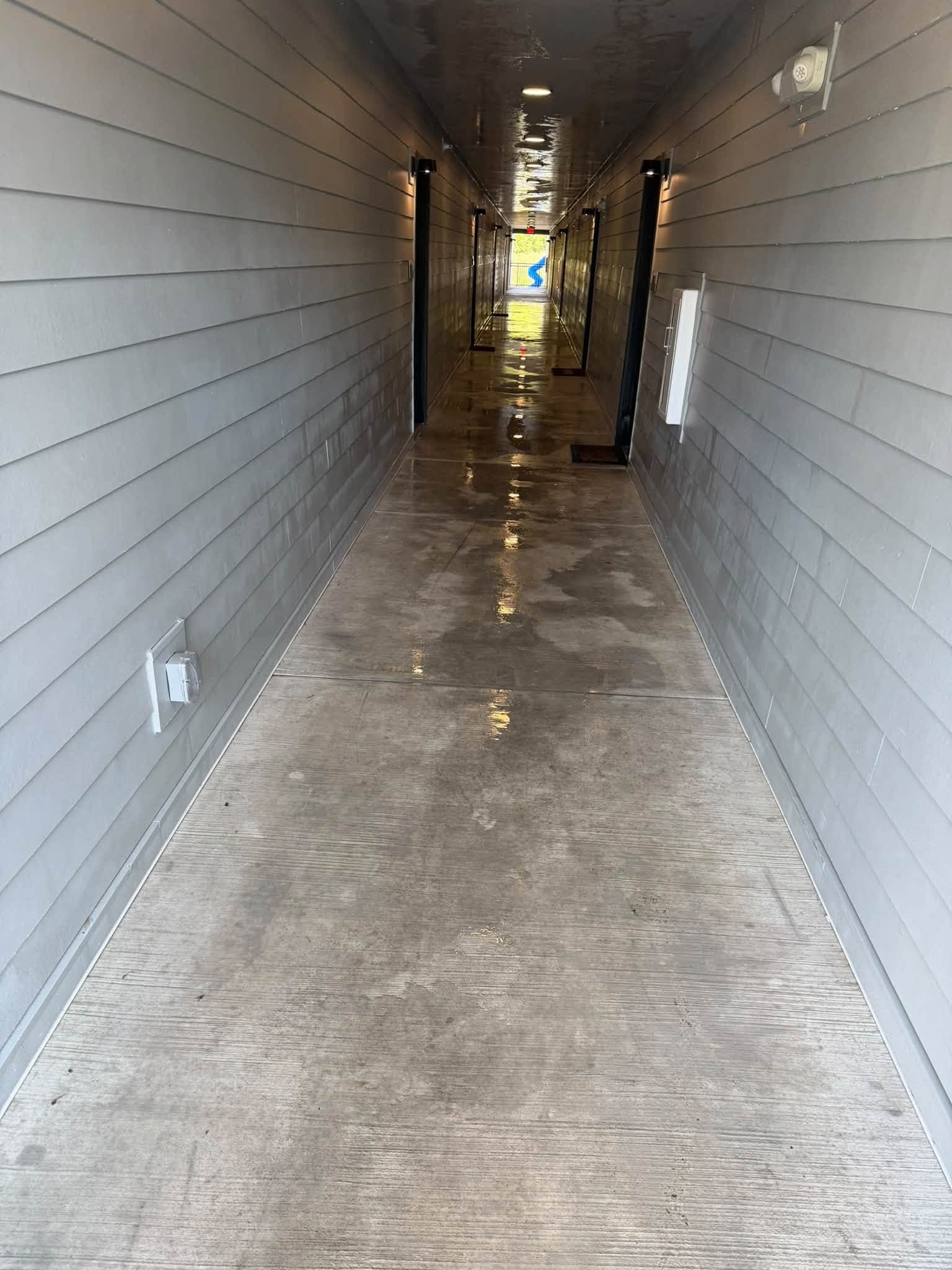 The same apartment breezeway washed down during commercial pressure washing