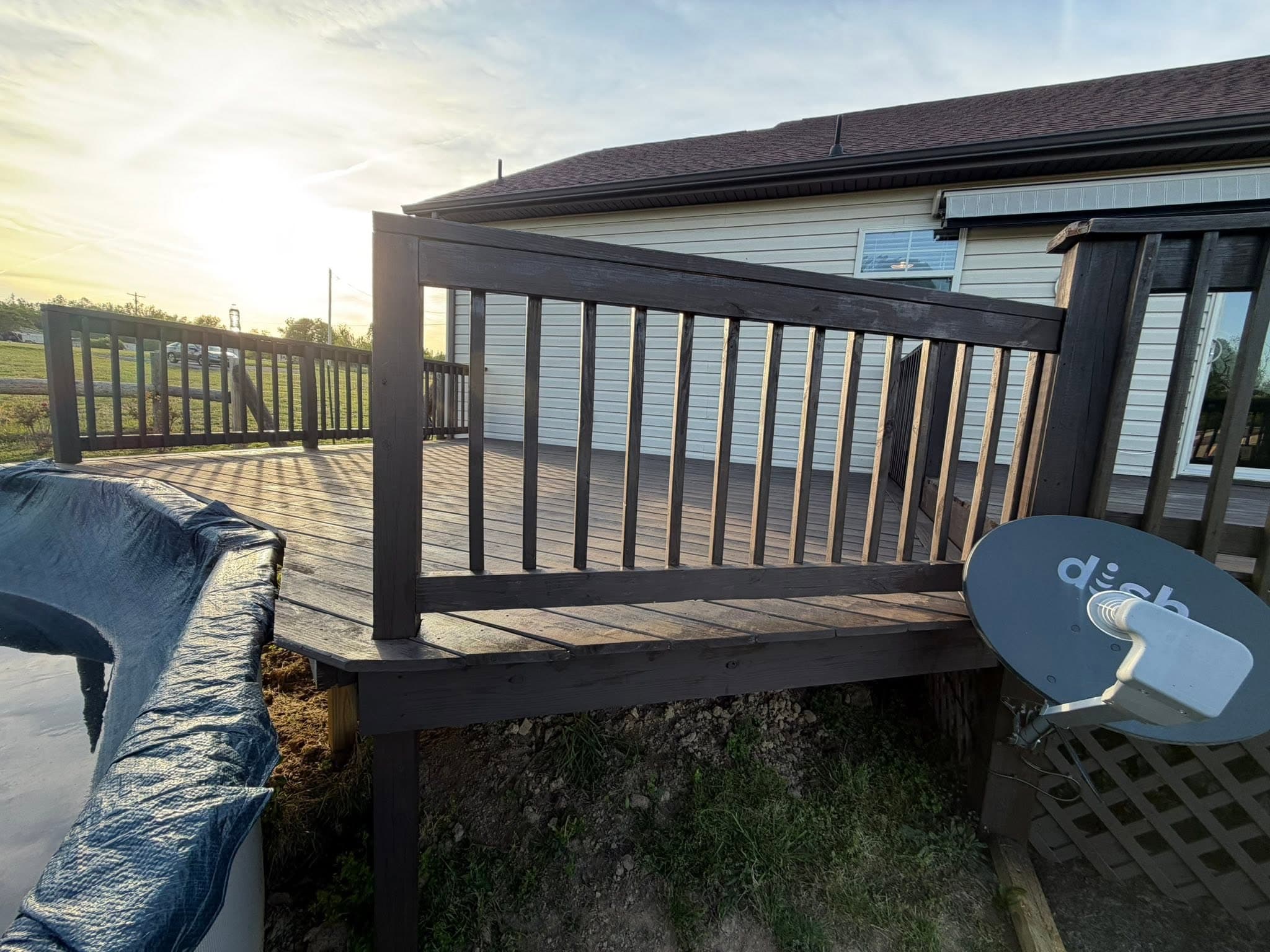 The same deck and railing after deck staining, finished dark brown