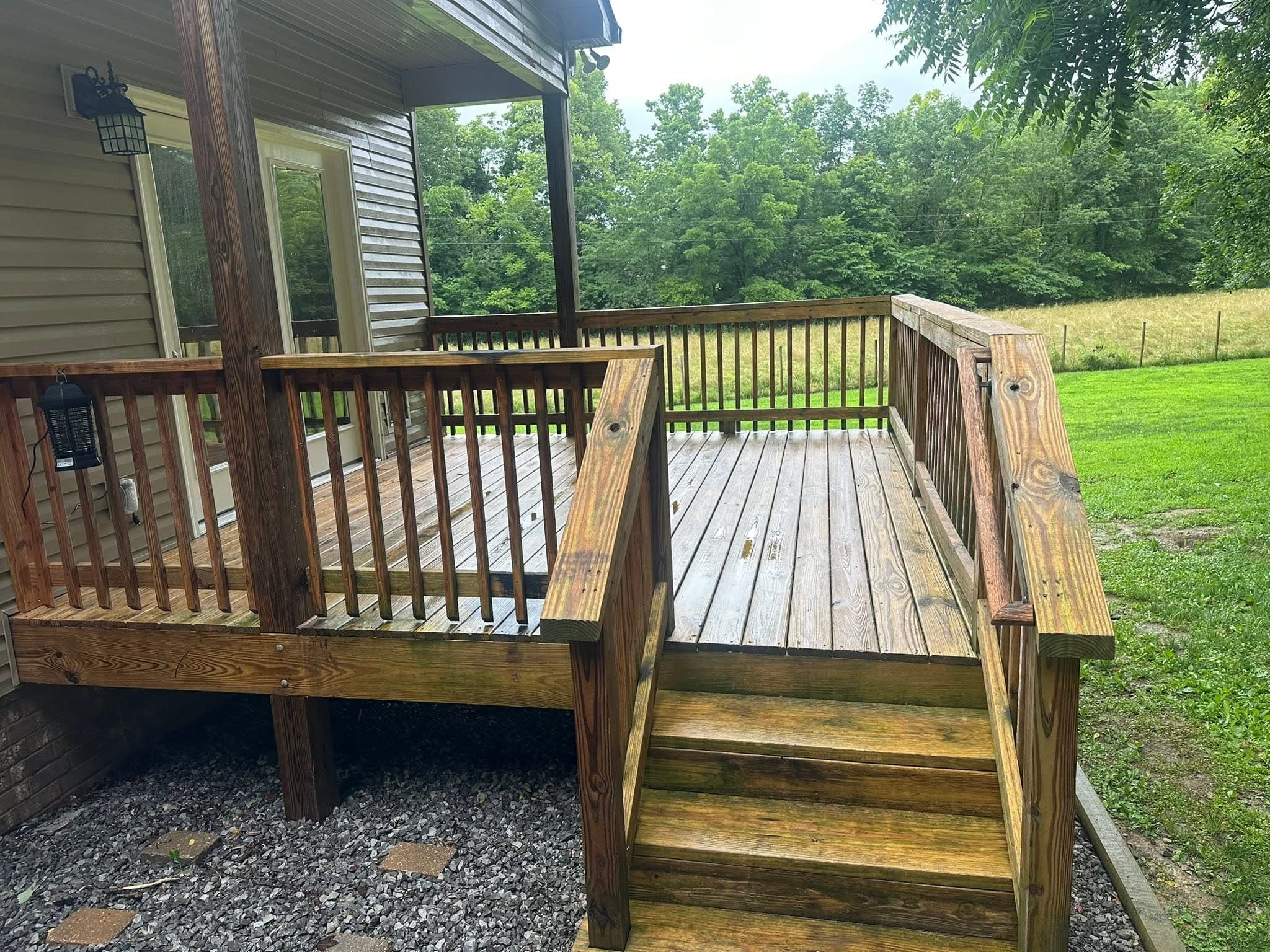 A covered wooden deck and its stairs after a deck wash