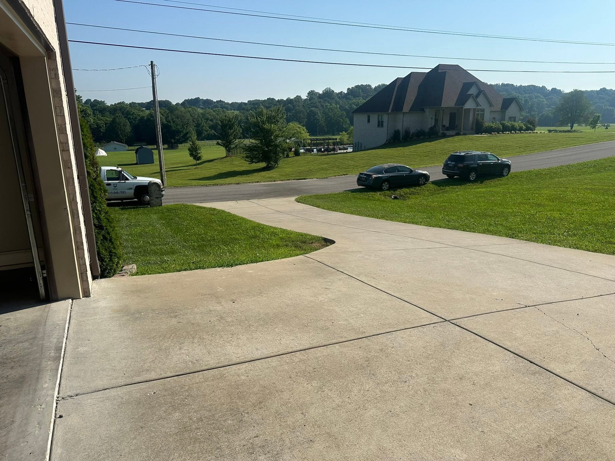 A concrete driveway and apron after concrete cleaning, seen from the open garage