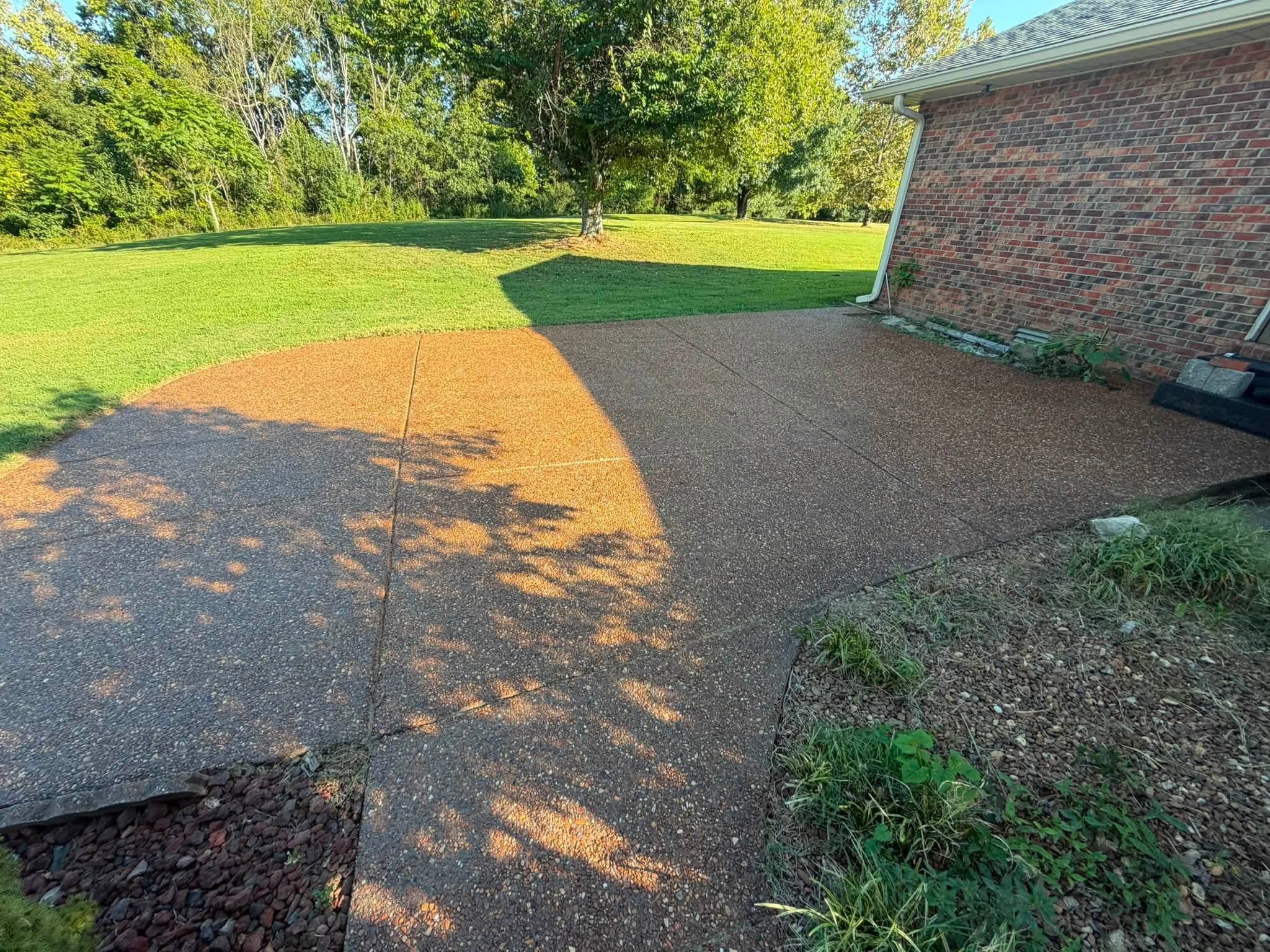 An exposed-aggregate driveway with a fresh wet-look finish after driveway sealing