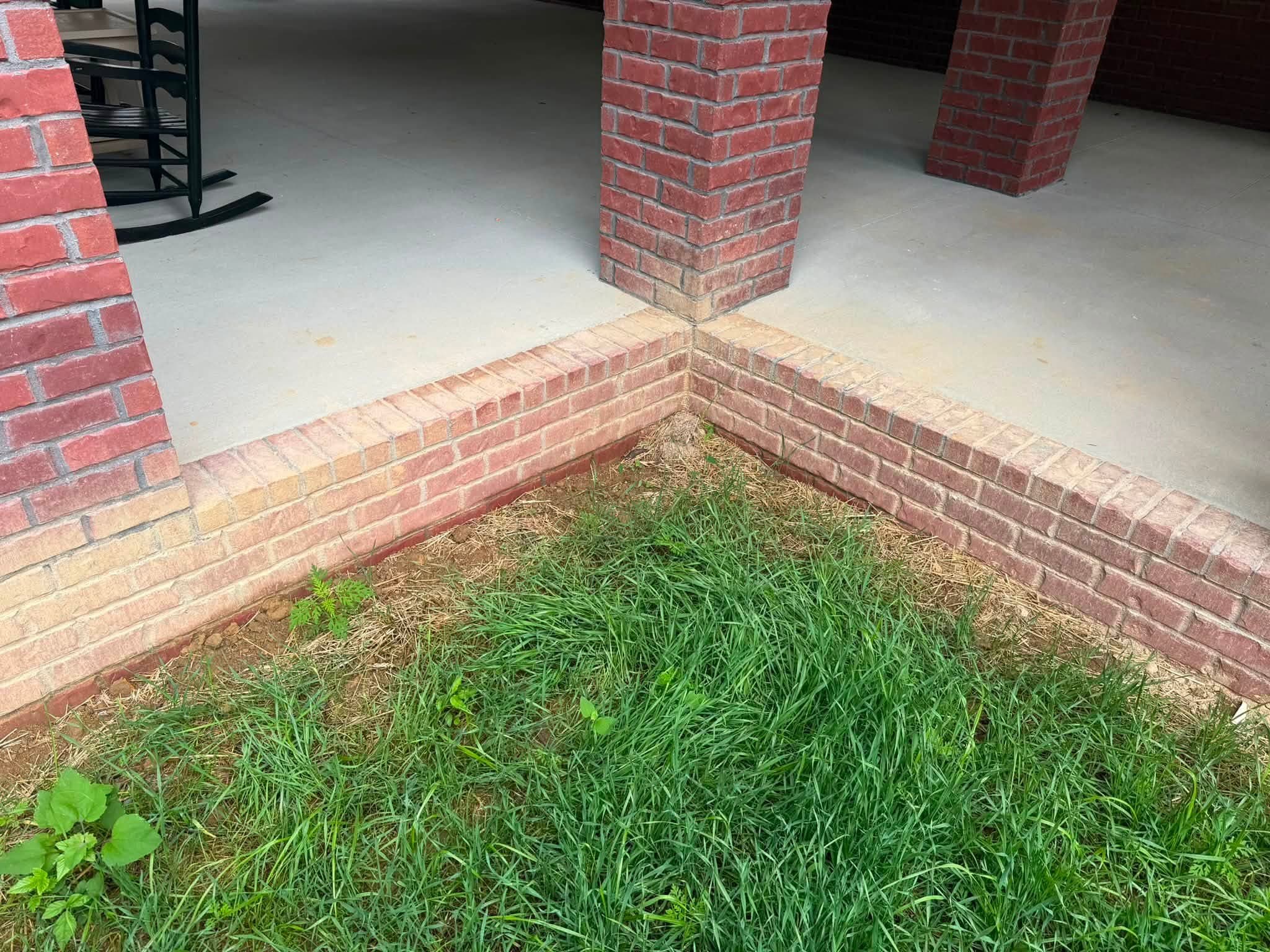 A faded brick porch corner before a brick and porch house wash