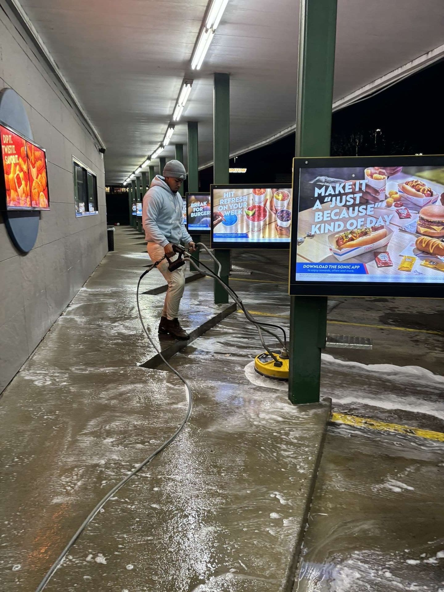 Pressure washing a commercial walkway during a scheduled clean