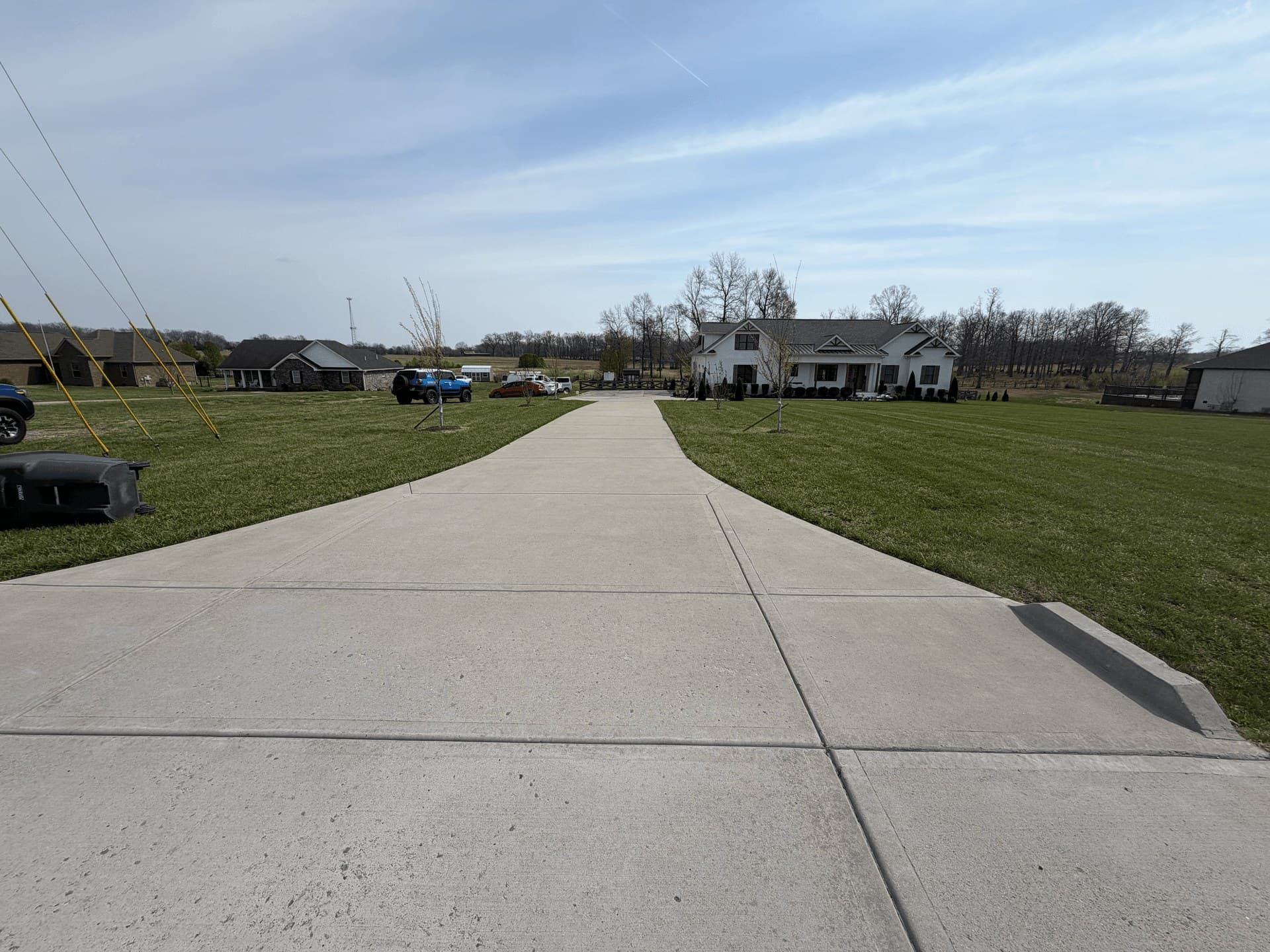 A long concrete driveway washed clean end to end after concrete cleaning
